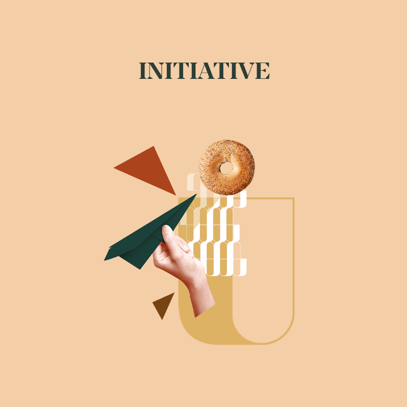 A hand launching a paper airplane towards a donut on a minimalistic background with abstract shapes